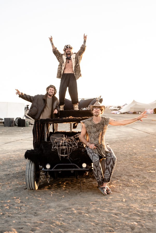 Camp mates cheering on top of the dune buggy